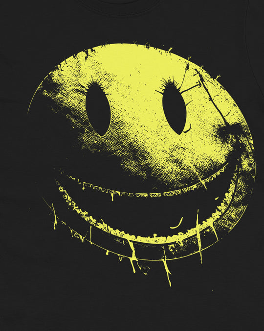 Close-up of a cracked yellow smiley face with eyelashes and dripping teeth printed on black fabric