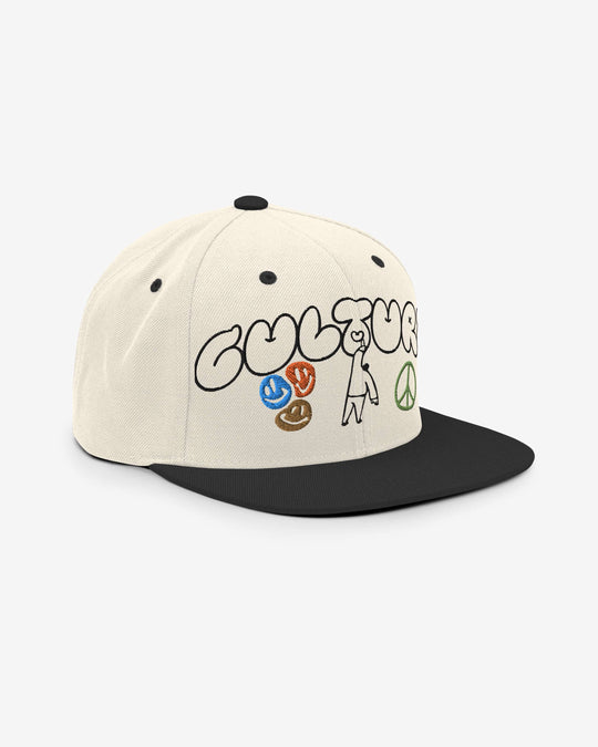 Cultural snapback in natural and black, angled front view showing the brim and embroidery