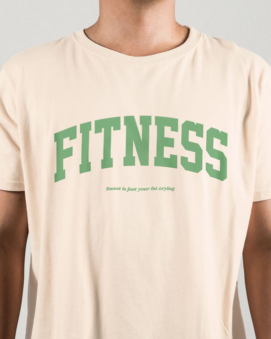 Fitness t-shirt in natural, worn by a model, close crop of the green "FITNESS" lettering