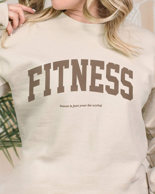 Fitness crewneck sweatshirt in sand on model, bold FITNESS graphic