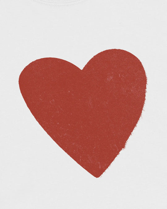 Close-up of the red worn-effect heart print on the white t-shirt