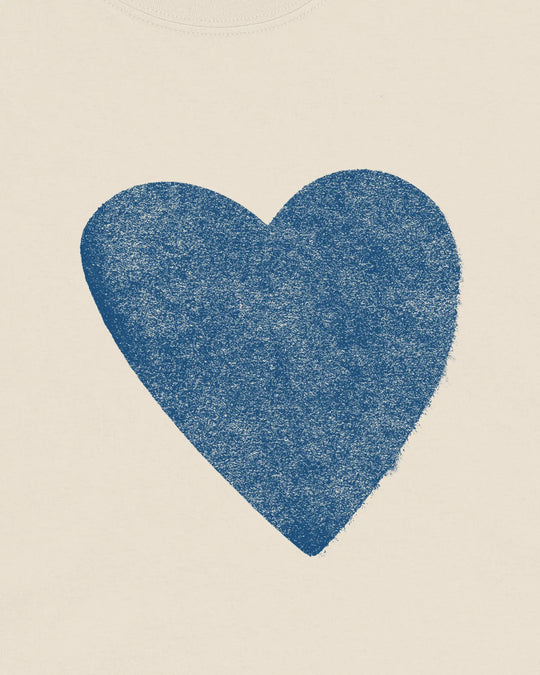 Close-up of the blue distressed heart print on the natural t-shirt