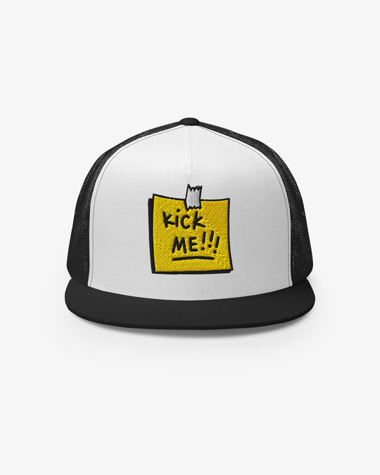 White and black trucker cap with embroidered Kick Me!!! sticky-note graphic, front view