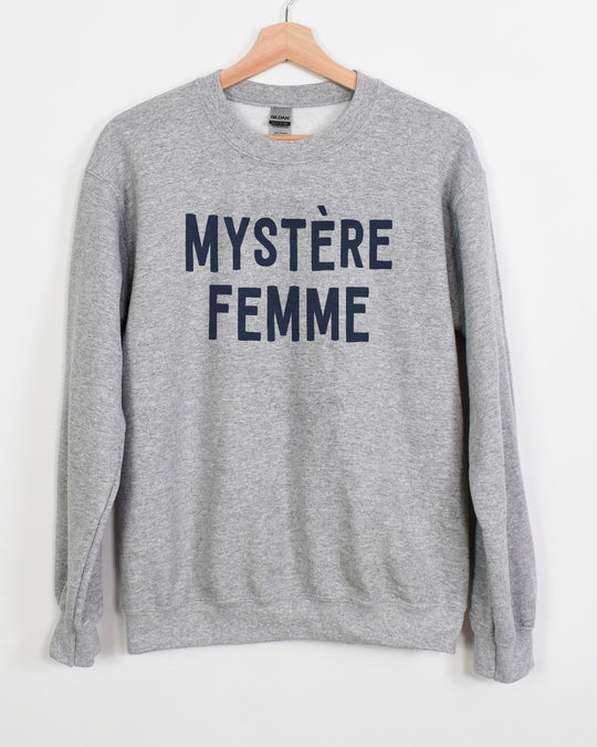 Mystère Femme sweatshirt in sport grey with navy lettering on a hanger