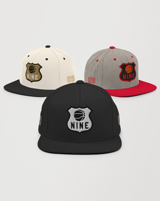 Nine snapback cap shown in natural, grey heather, and black