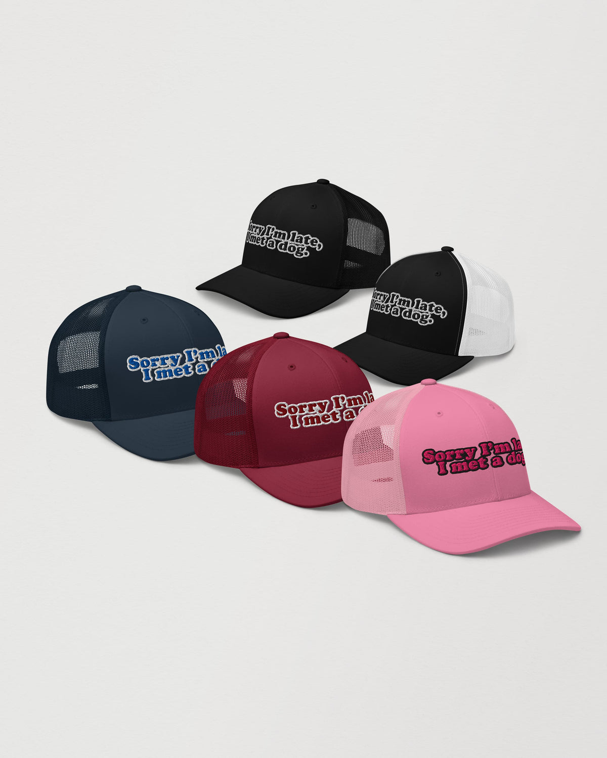 Sorry I'm Late, I Met A Dog trucker hat, cranberry, black, black and white, navy, and pink colorways