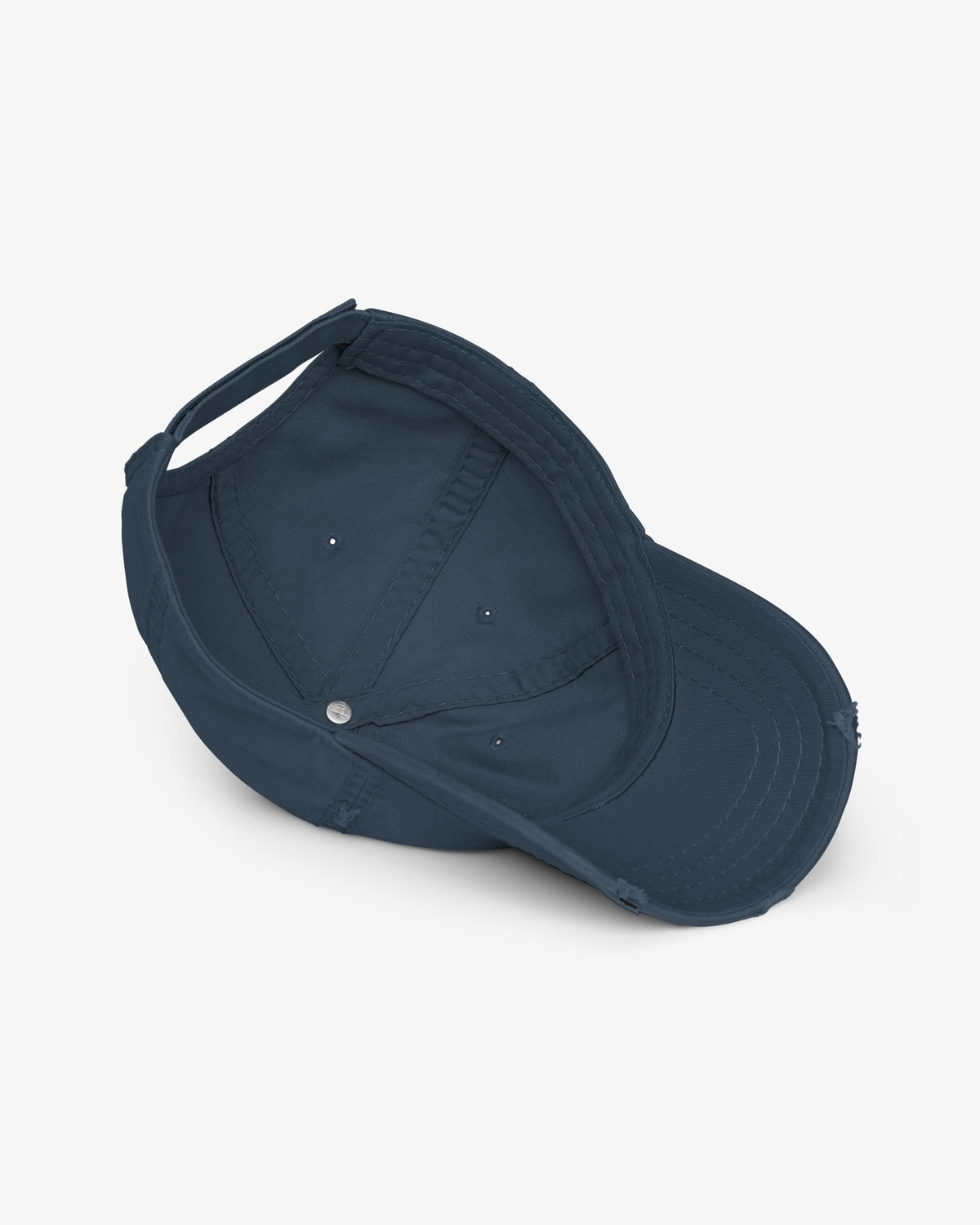 Inside of navy distressed dad hat showing seamed crown, sweatband and eyelets
