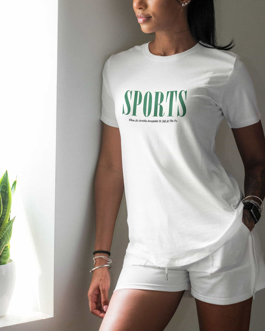 Sports t-shirt in white, green "SPORTS" wordmark, worn by a model