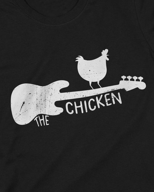 Close-up of The Chicken print, white distressed bass guitar with a chicken perched on the neck and "THE CHICKEN" lettering